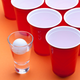 Beer pong cups and ball on table